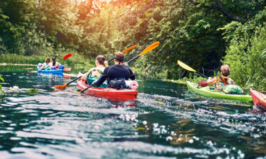 Happy best friends having fun on a kayaks. Kayaking on the river.