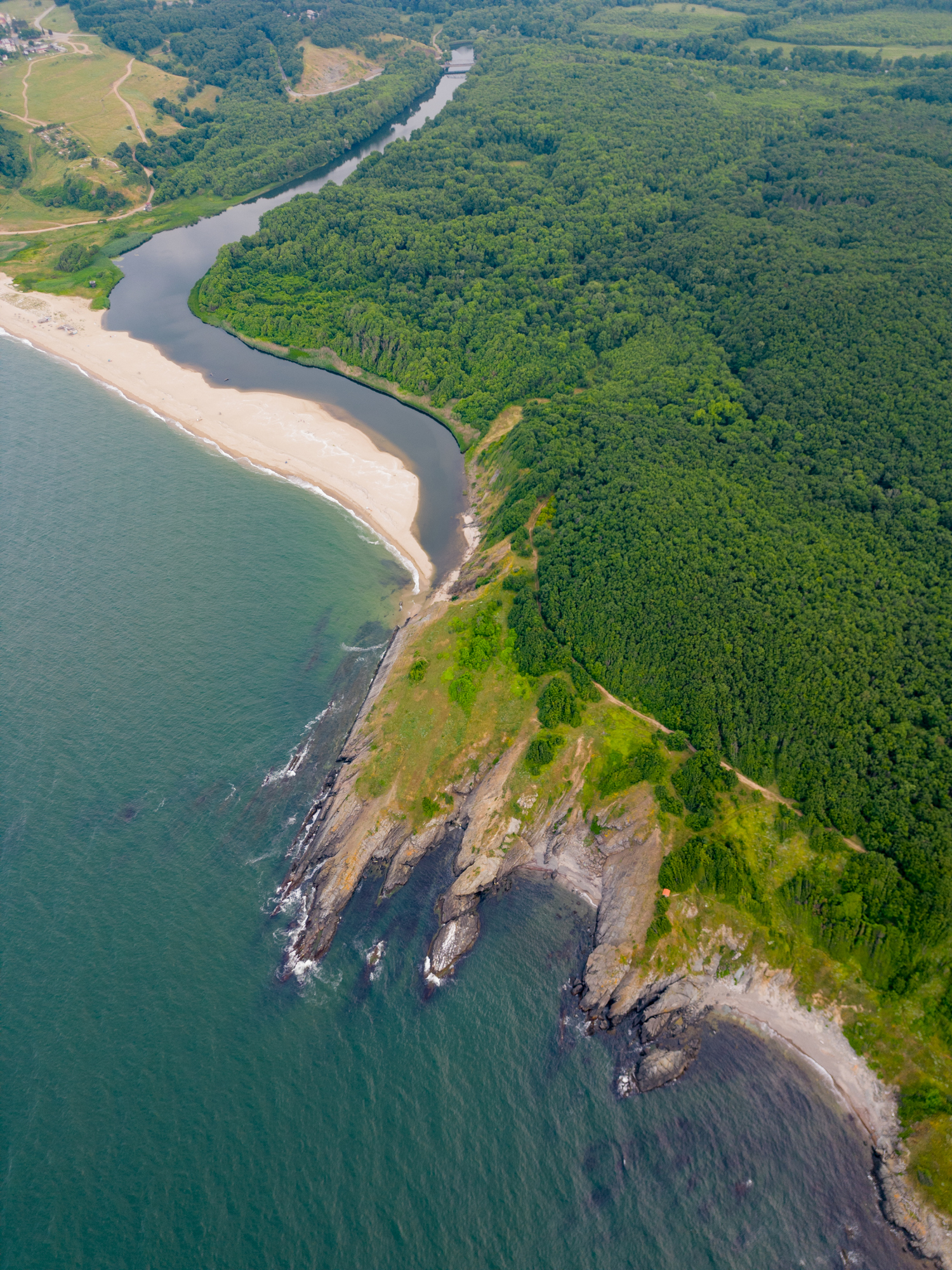 An aerial view of the rocky coastline of the Black Sea in southern Bulgaria near Sinemorets town, showcasing its rugged beauty and coastal splendor.